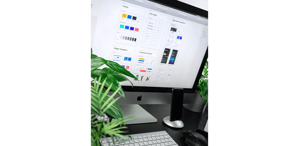 An iMac displaying a design system on the screen